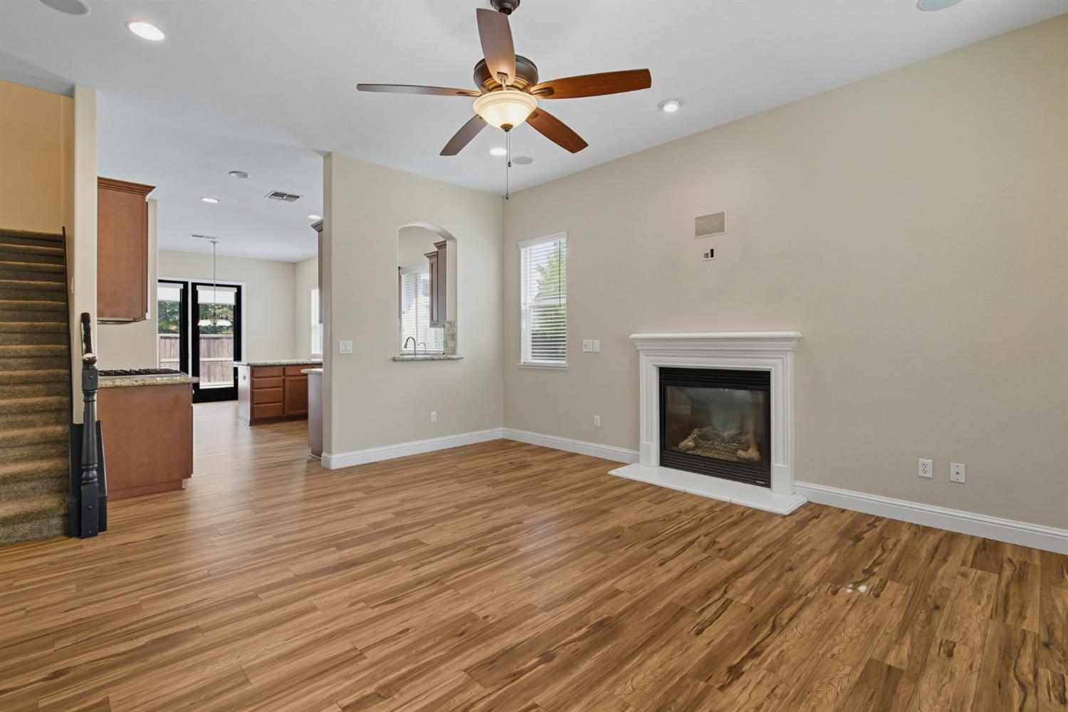 433 Travertine Drive Ripon, CA 95366 - Photo 2 of 38 a view of empty room with wooden floor and a fireplace