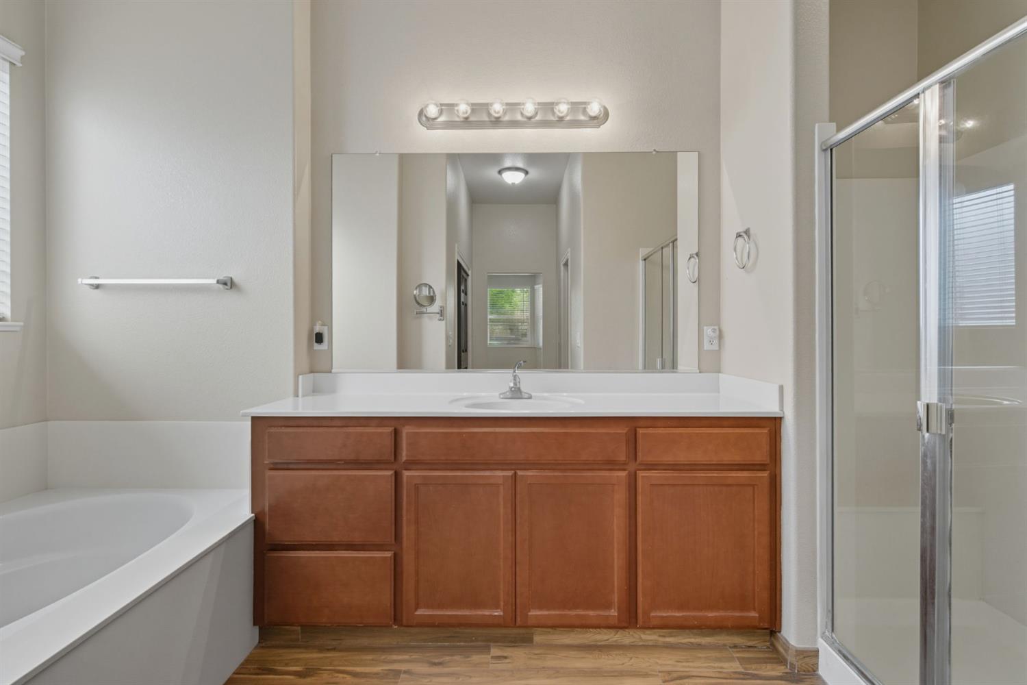 433 Travertine Drive Ripon, CA 95366 - Photo 24 of 38 a spacious bathroom with a granite countertop sink and a mirror