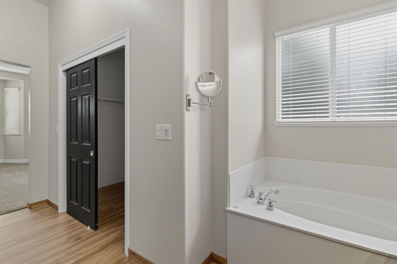433 Travertine Drive Ripon, CA 95366 - Photo 25 of 38 a bathroom with a bathtub and a shower