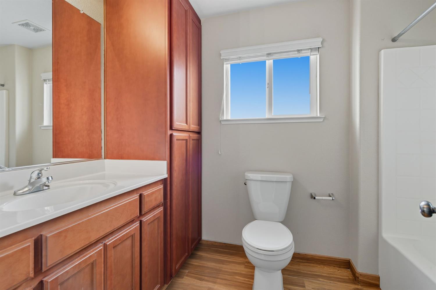 433 Travertine Drive Ripon, CA 95366 - Photo 29 of 38 a bathroom with a toilet sink and mirror
