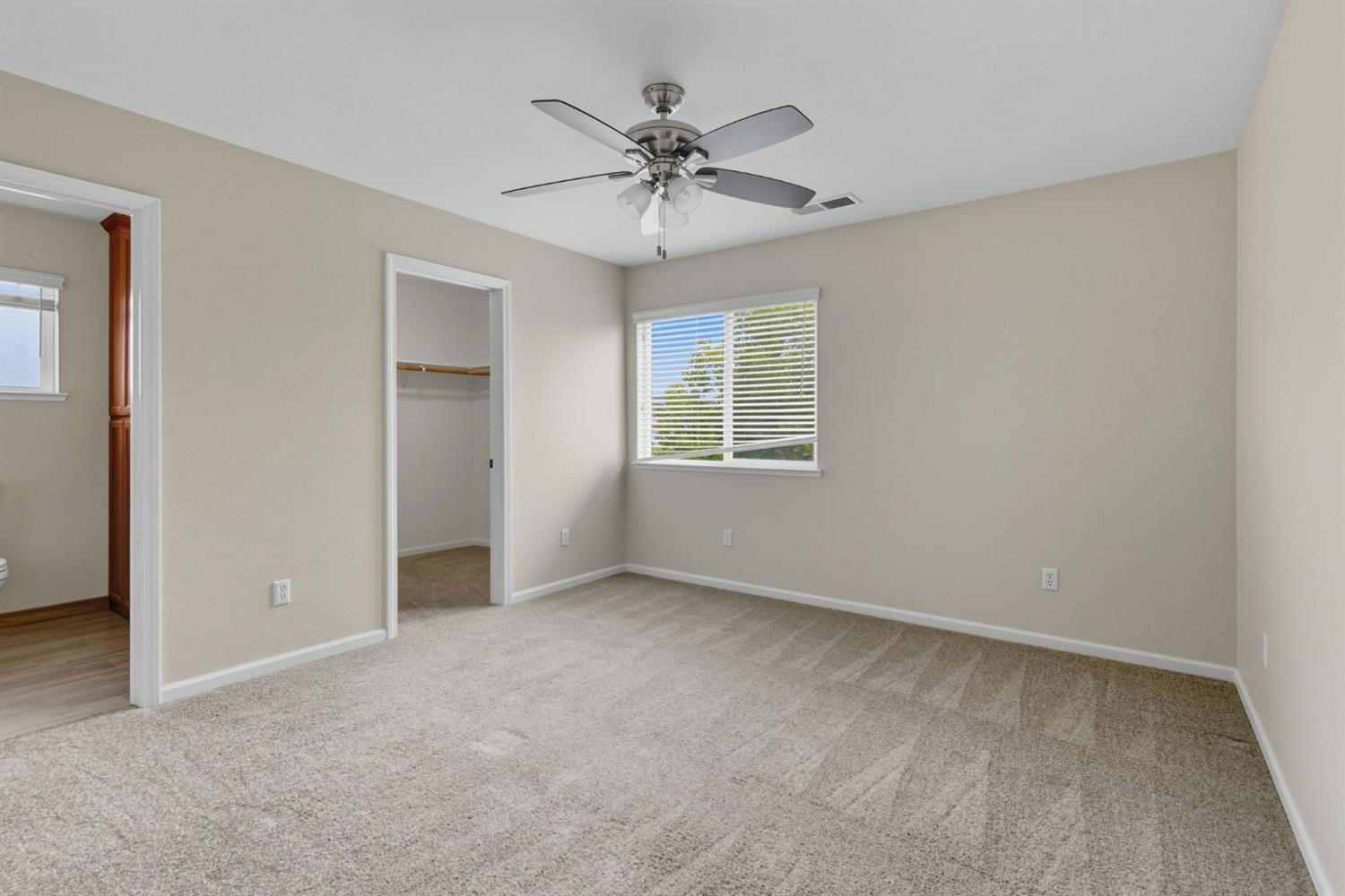 433 Travertine Drive Ripon, CA 95366 - Photo 30 of 38 an empty room with a ceiling fan and a window