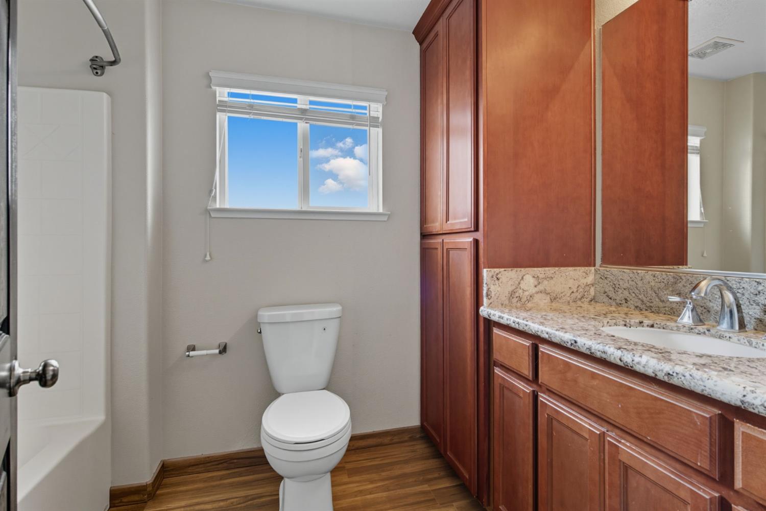 433 Travertine Drive Ripon, CA 95366 - Photo 31 of 38 a bathroom with a toilet sink and mirror