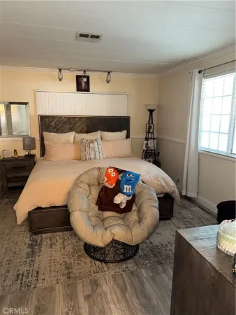 a bed sitting in a bedroom next to a window