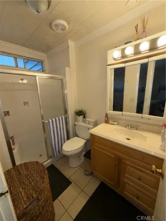 a bathroom with a sink mirror vanity and toilet