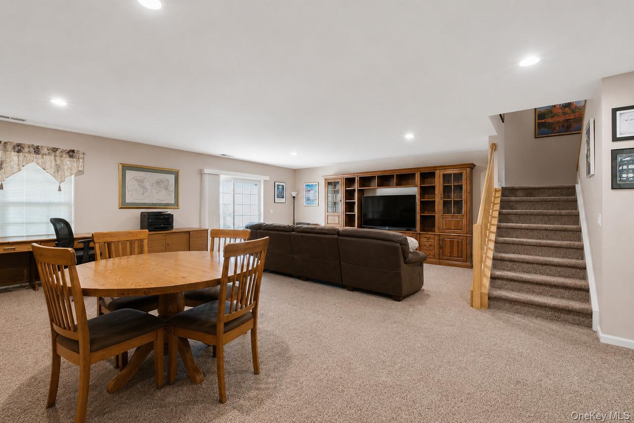64 Roma Orchard Road Peekskill, NY 10566 - Photo 31 of 40 Spacious recreation area featuring neutral carpeting, a built-in entertainment center, recessed lighting, and a sliding glass door