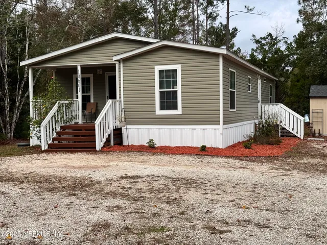 a front view of house with yard outdoor seating and barbeque oven