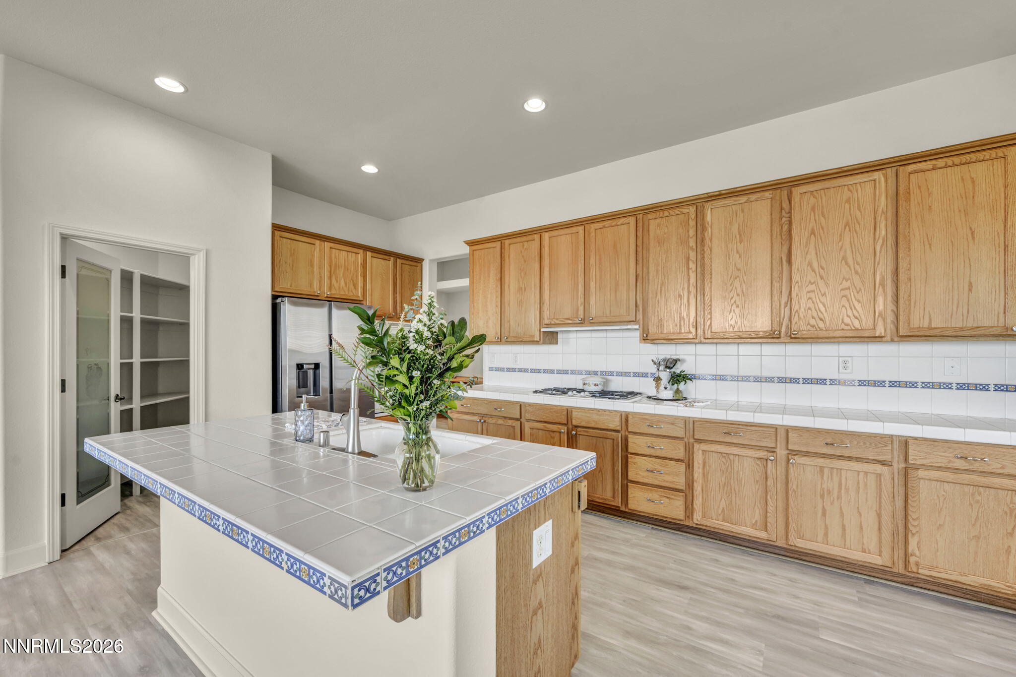 574 Echo Ridge Court Reno, NV 89511 - Photo 24 of 58 a kitchen with stainless steel appliances granite countertop a sink a window and wooden cabinets