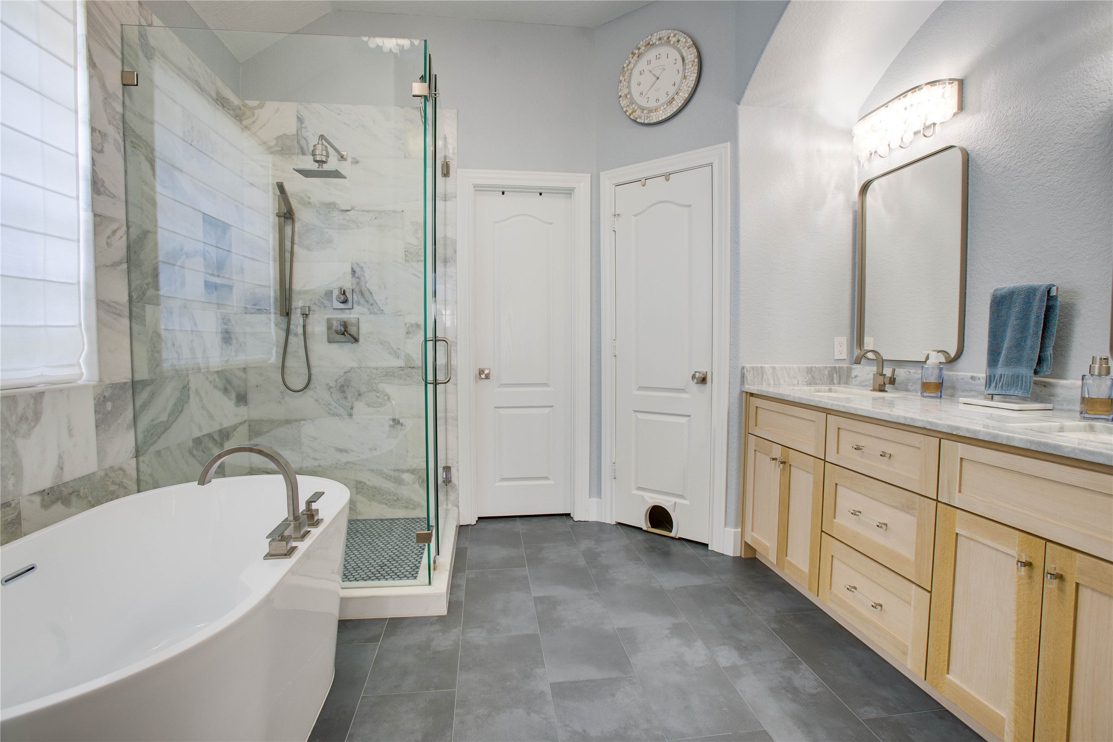 30 Fraiser Fir Place Spring, TX 77389 - Photo 16 of 35 a bathroom with a tub a sink and a large mirror