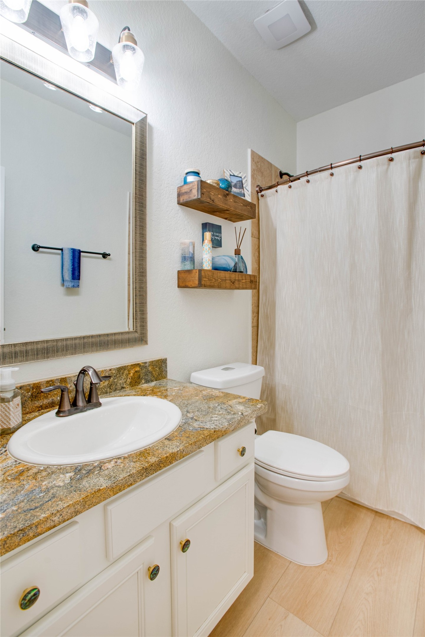 30 Fraiser Fir Place Spring, TX 77389 - Photo 20 of 35 a bathroom with a granite countertop sink toilet and a mirror
