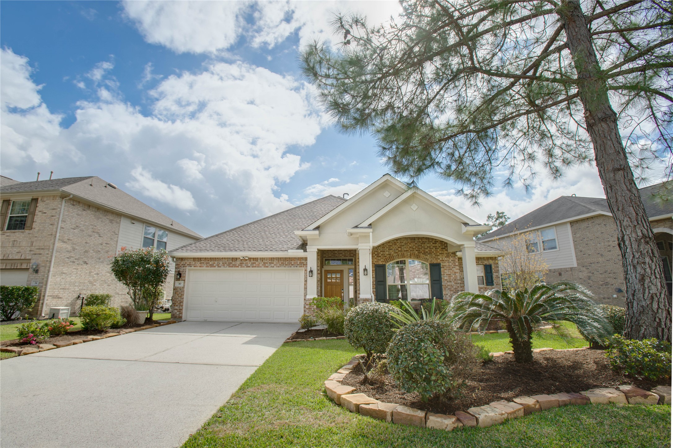 30 Fraiser Fir Place Spring, TX 77389 - Photo 2 of 35 a front view of a house with garden