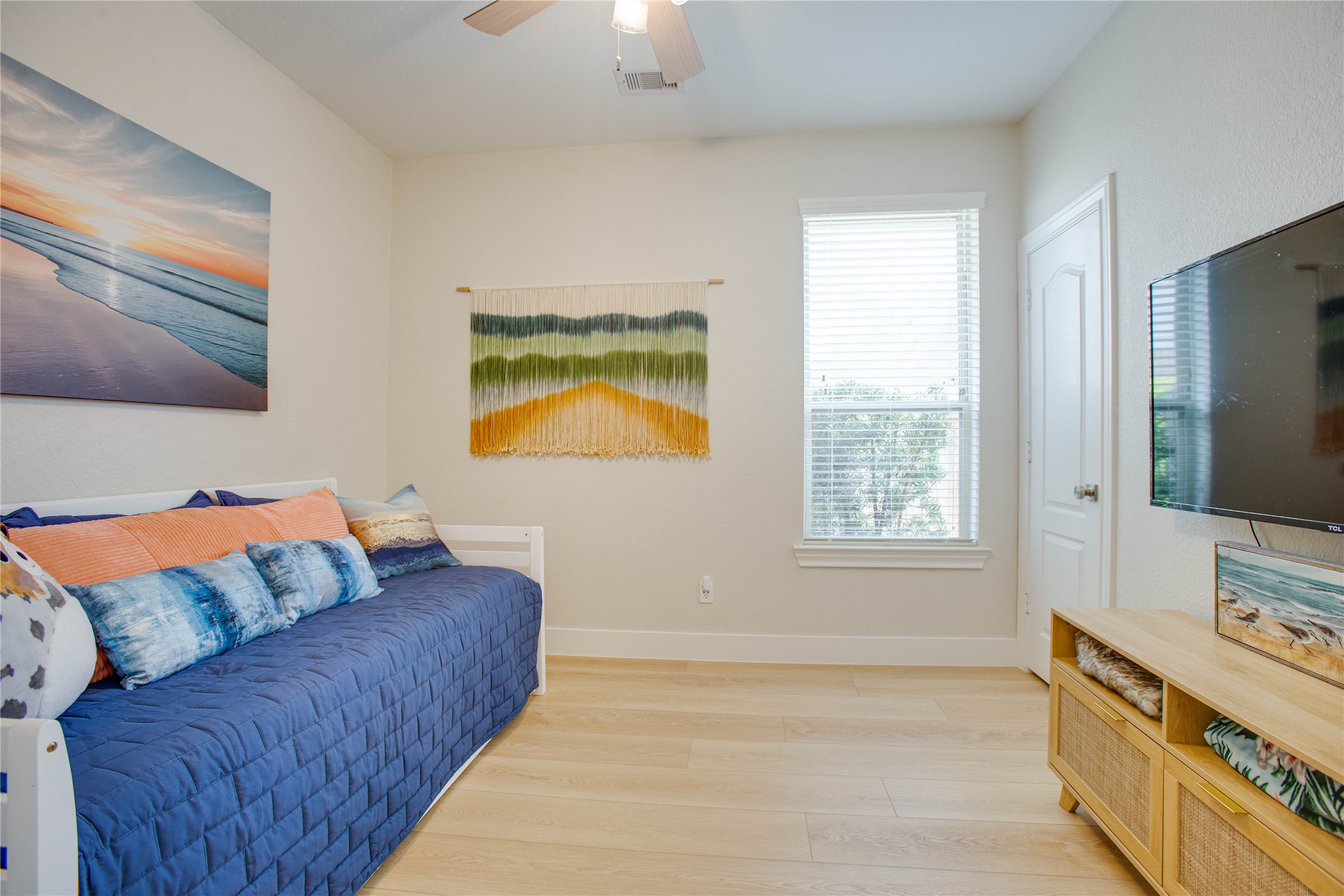 30 Fraiser Fir Place Spring, TX 77389 - Photo 21 of 35 a living room with a couch and a flat screen tv