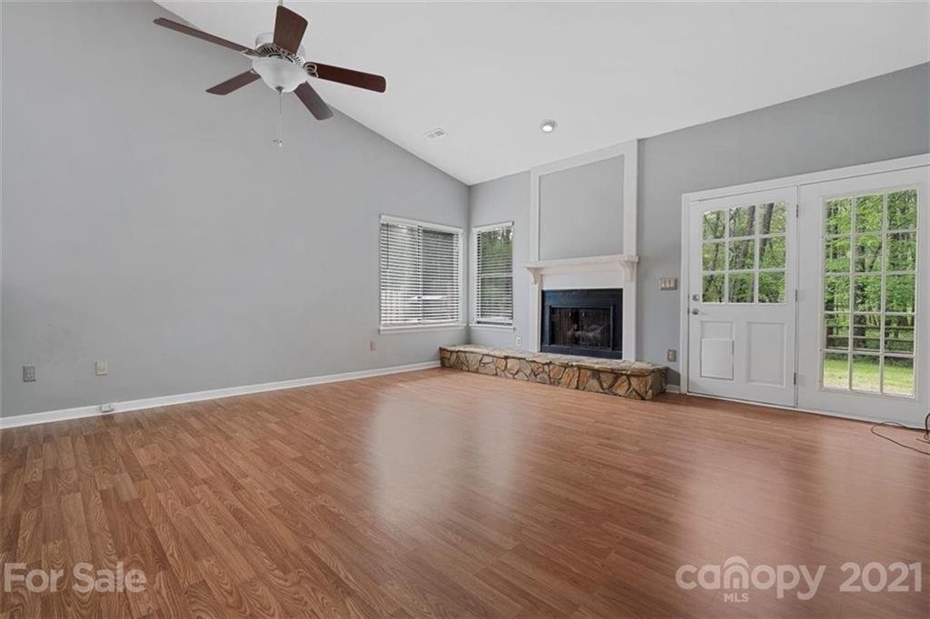 8508 Rittenhouse Circle Charlotte, NC 28270 - Photo 12 of 44 an empty room with wooden floor fireplace and windows