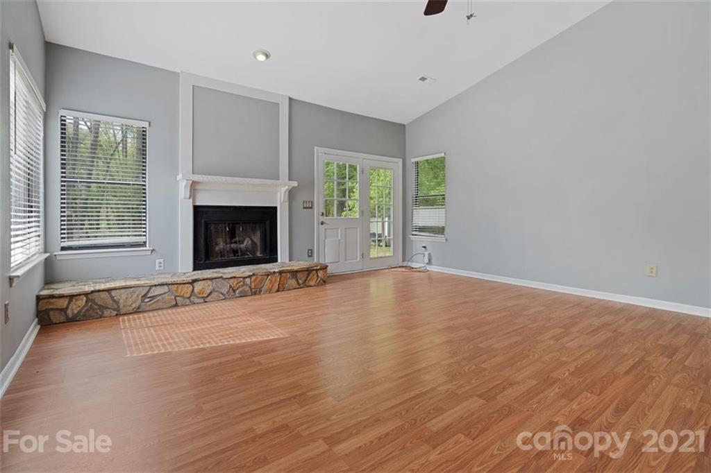 8508 Rittenhouse Circle Charlotte, NC 28270 - Photo 14 of 44 wooden floor fireplace and windows in an empty room