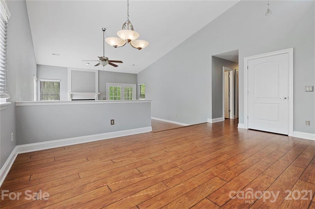 8508 Rittenhouse Circle Charlotte, NC 28270 - Photo 19 of 44 a view of a room with wooden floor and chandelier