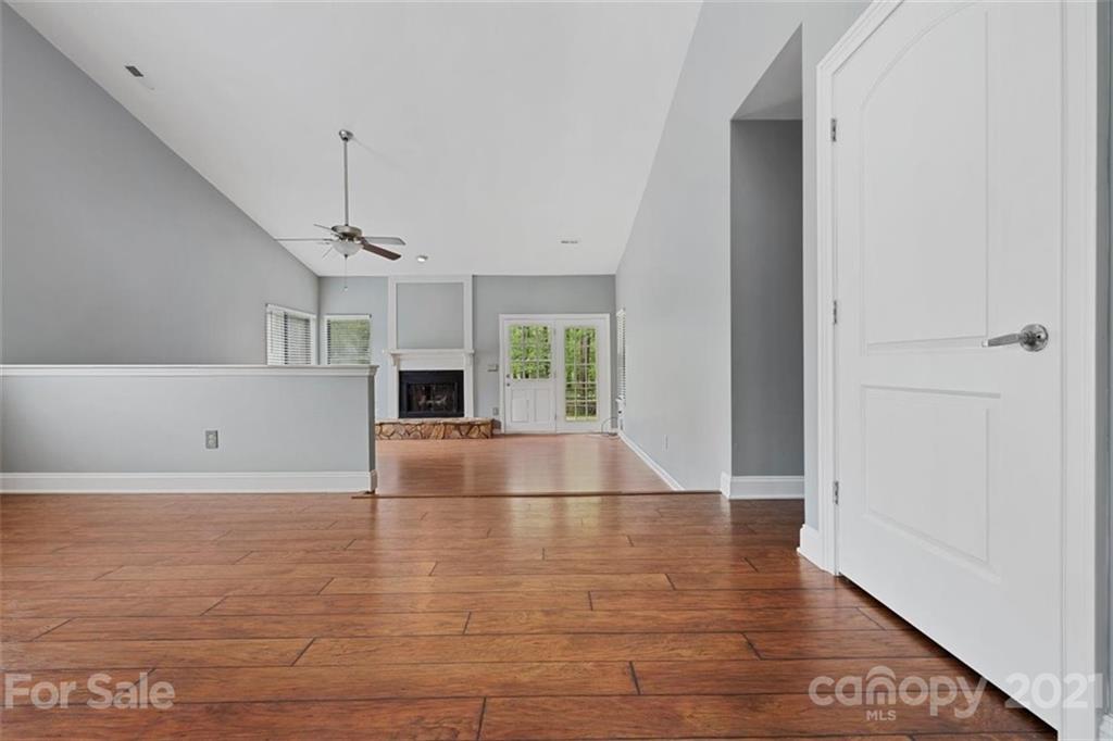 8508 Rittenhouse Circle Charlotte, NC 28270 - Photo 5 of 44 an empty room with wooden floor and fireplace
