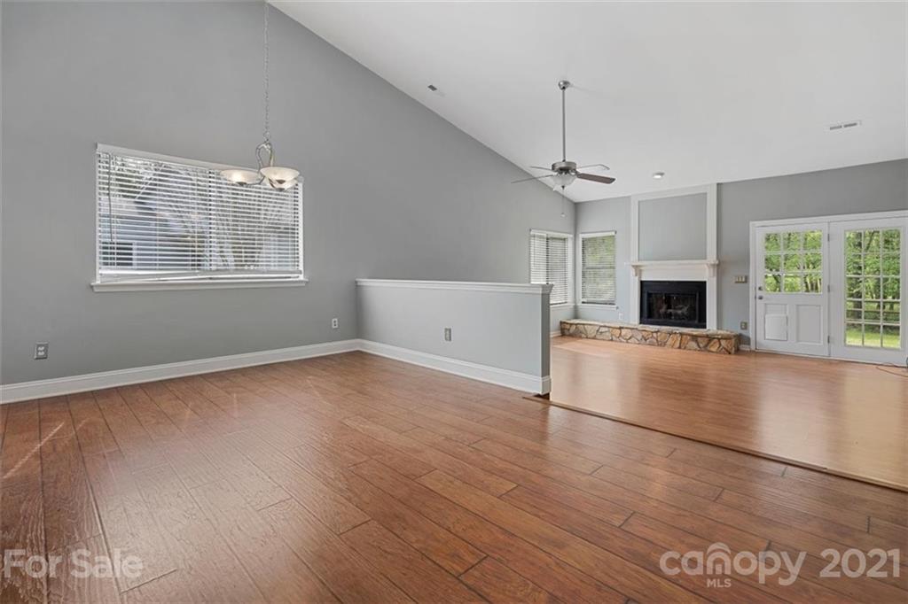 8508 Rittenhouse Circle Charlotte, NC 28270 - Photo 7 of 44 an empty room with wooden floor fireplace and windows