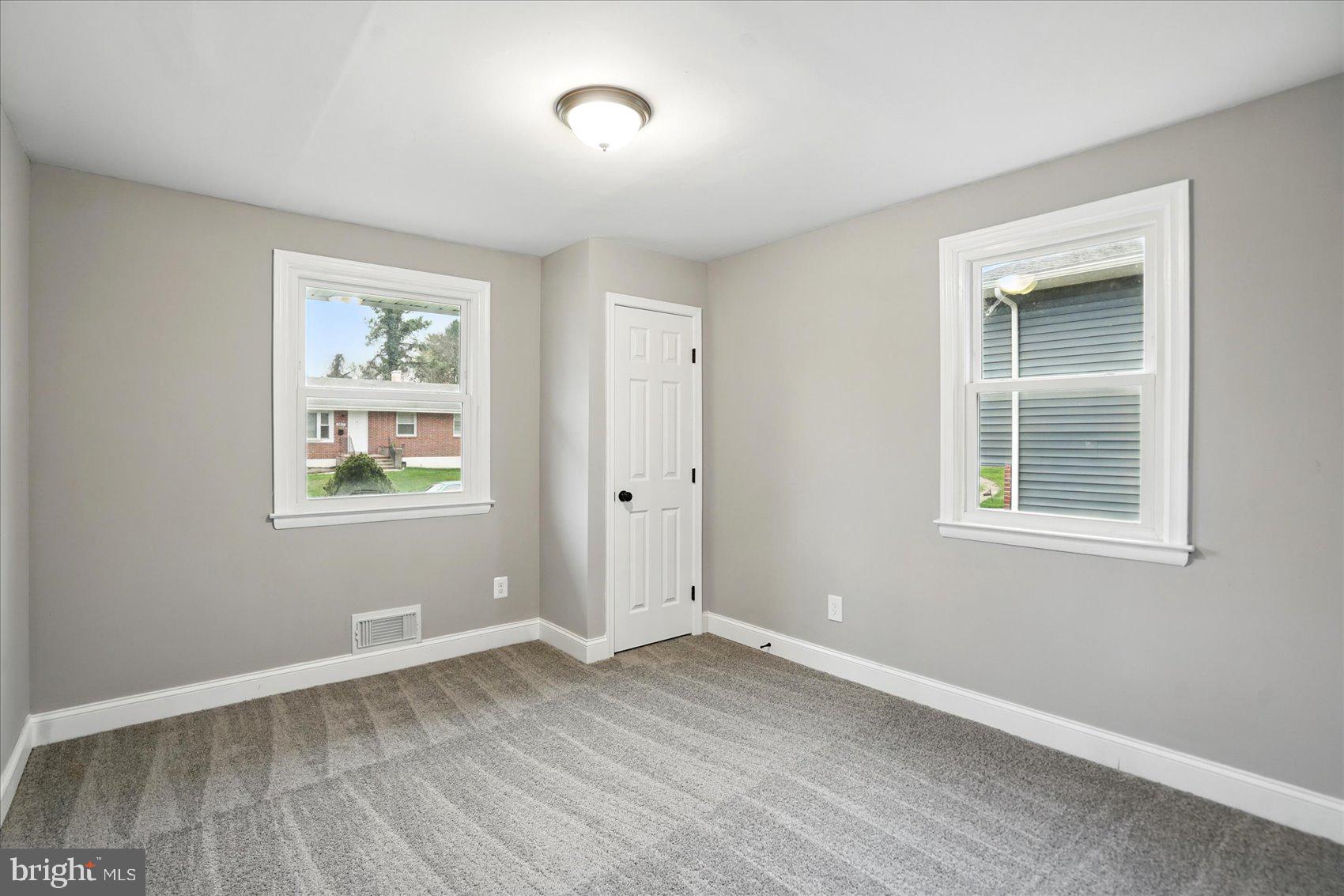 3816 Cherrybrook Road Randallstown, MD 21133 - Photo 19 of 35 an empty room with wooden floor and windows