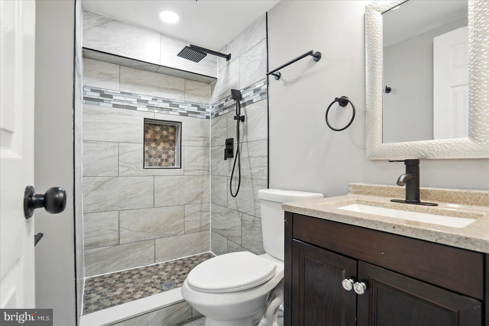 3816 Cherrybrook Road Randallstown, MD 21133 - Photo 26 of 35 a bathroom with a sink a toilet and shower