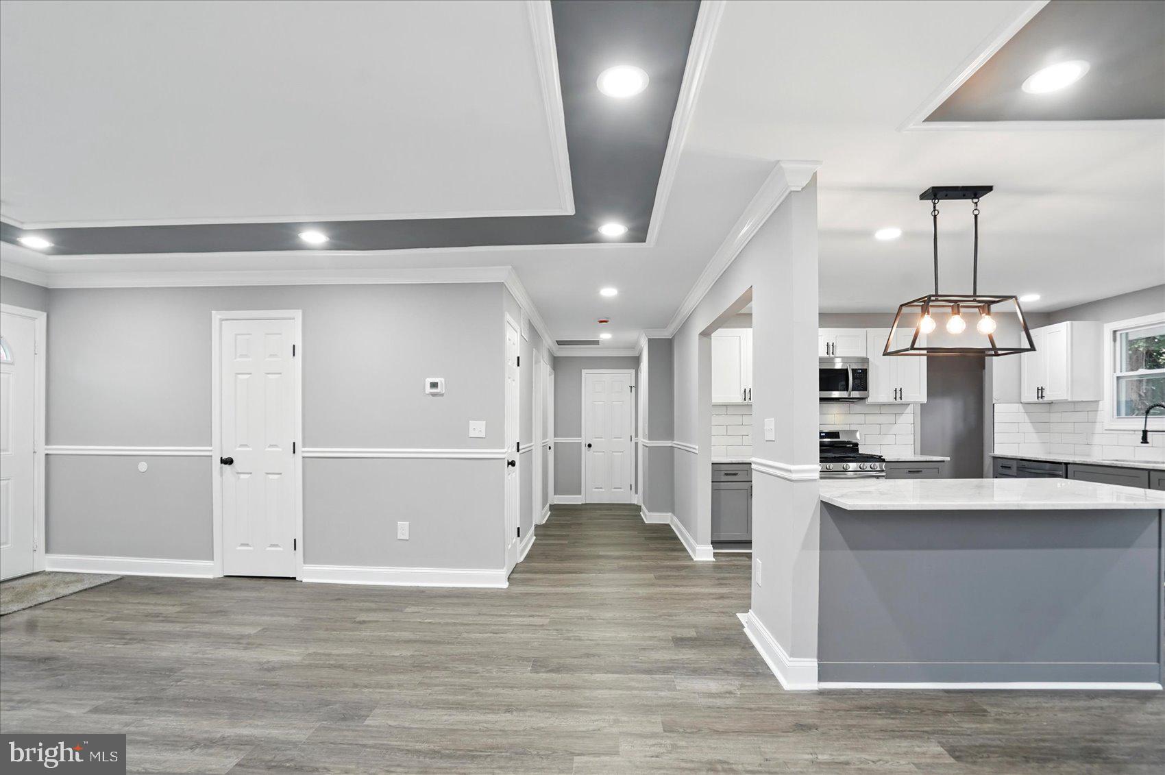 3816 Cherrybrook Road Randallstown, MD 21133 - Photo 6 of 35 a large kitchen with a center island wooden floor stainless steel appliances and cabinets