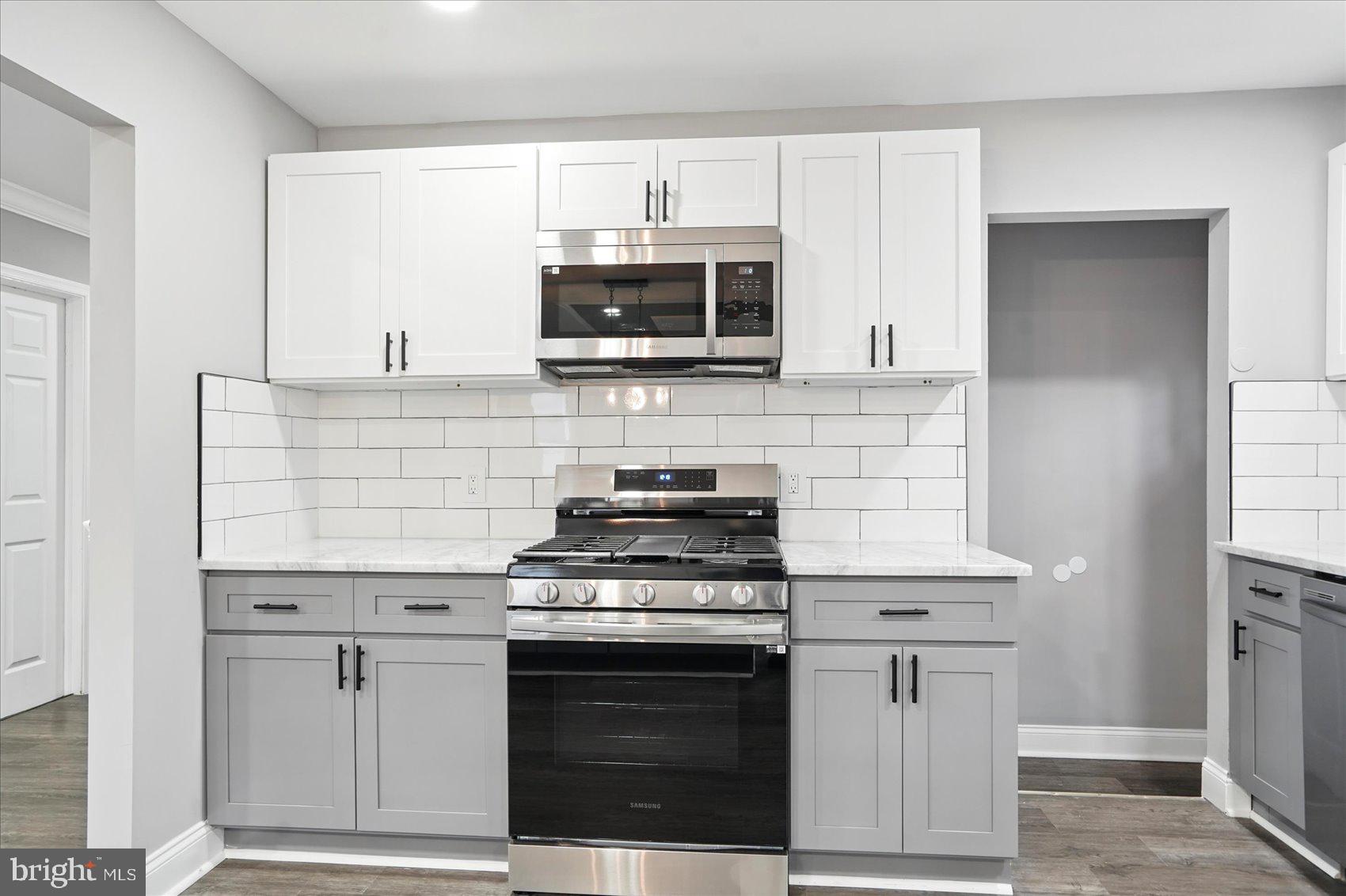3816 Cherrybrook Road Randallstown, MD 21133 - Photo 10 of 35 a kitchen with cabinets stainless steel appliances and wooden floor