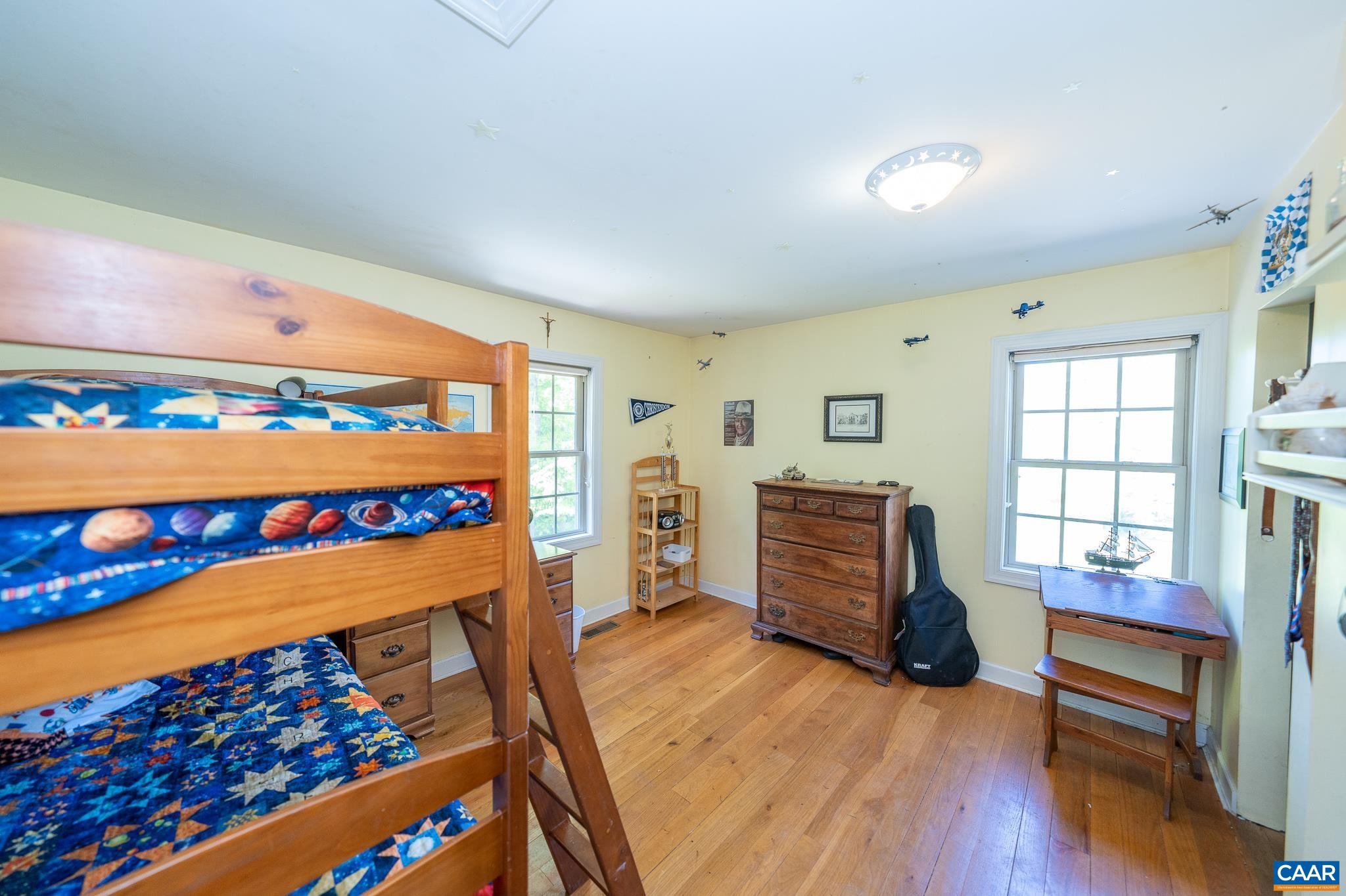 5920 Mechunk Ridge Lane Keswick, VA 22947 - Photo 17 of 49 wooden floor in a bedroom with a bed and a window
