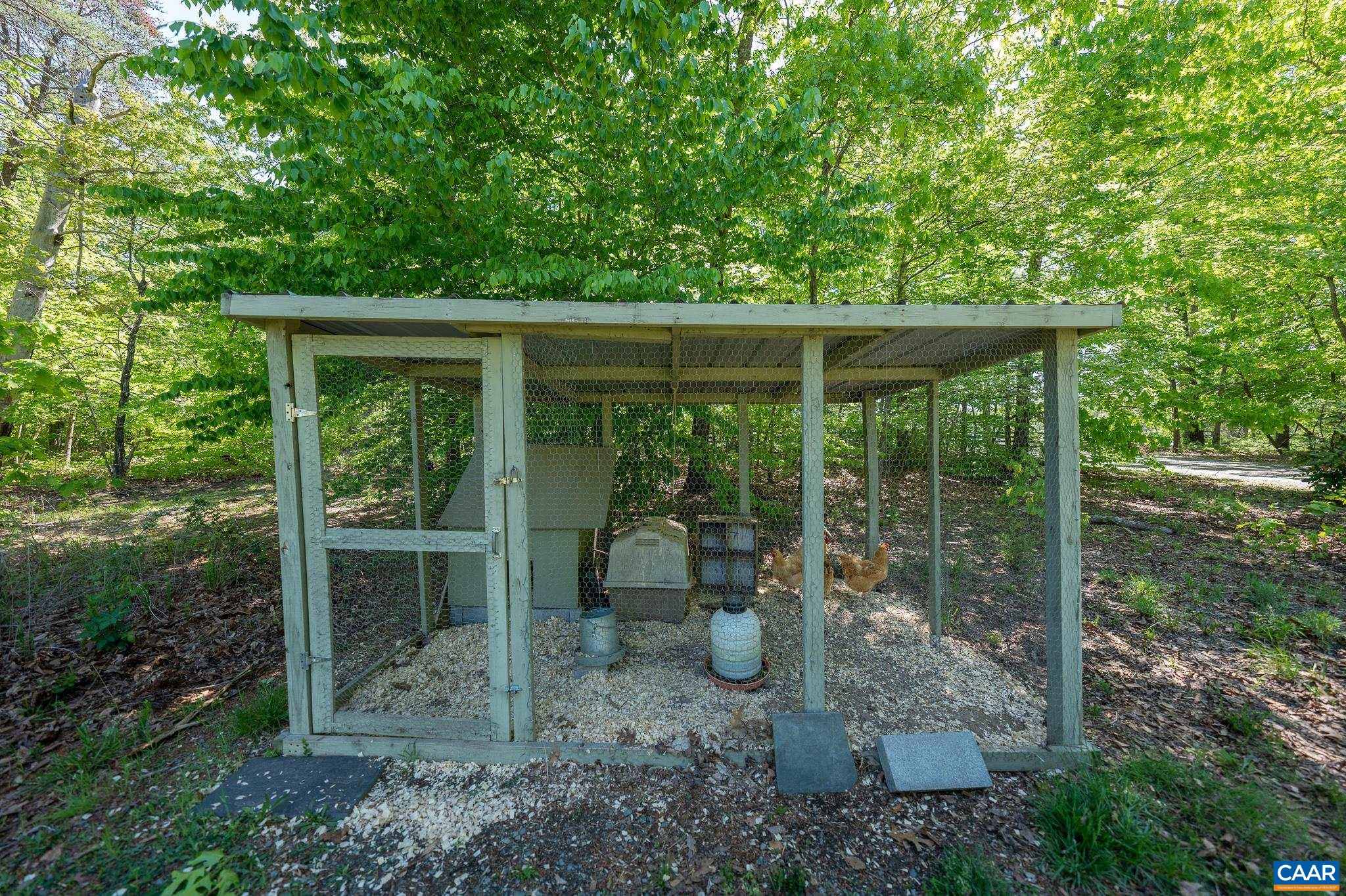 5920 Mechunk Ridge Lane Keswick, VA 22947 - Photo 42 of 49 a view of a backyard with floor to ceiling window and wooden fence