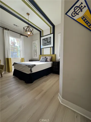 a spacious bedroom with a bed and a window