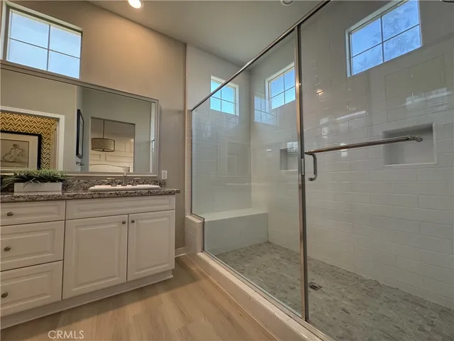 a bathroom with a granite countertop sink mirror and shower