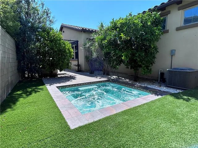 a view of a backyard with plants and a patio