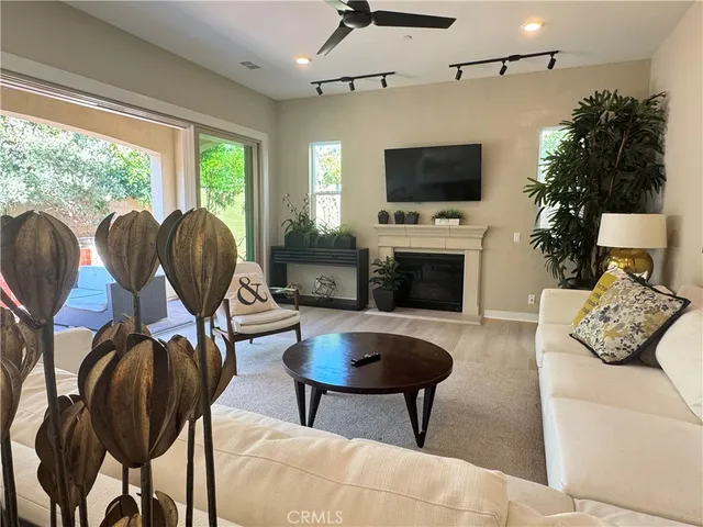 a living room with furniture fireplace and flat screen tv
