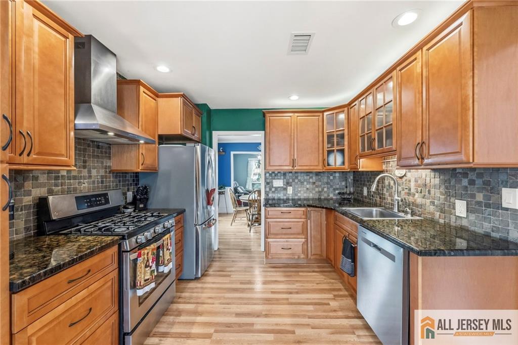 50 3rd Street Fords, NJ 08863 - Photo 15 of 36 a kitchen with stainless steel appliances granite countertop a stove sink and cabinets