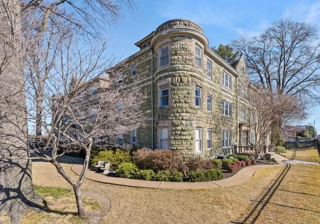 a view of a tall building with a yard