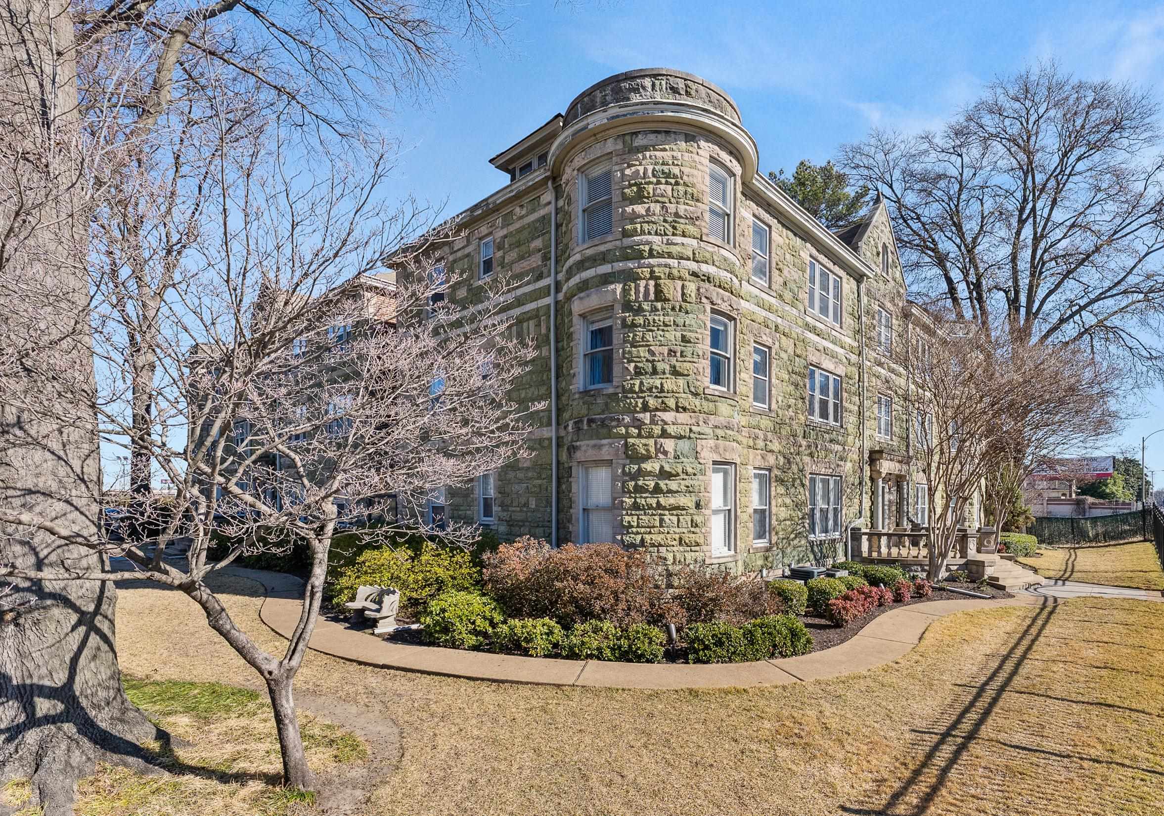 a view of a tall building with a yard
