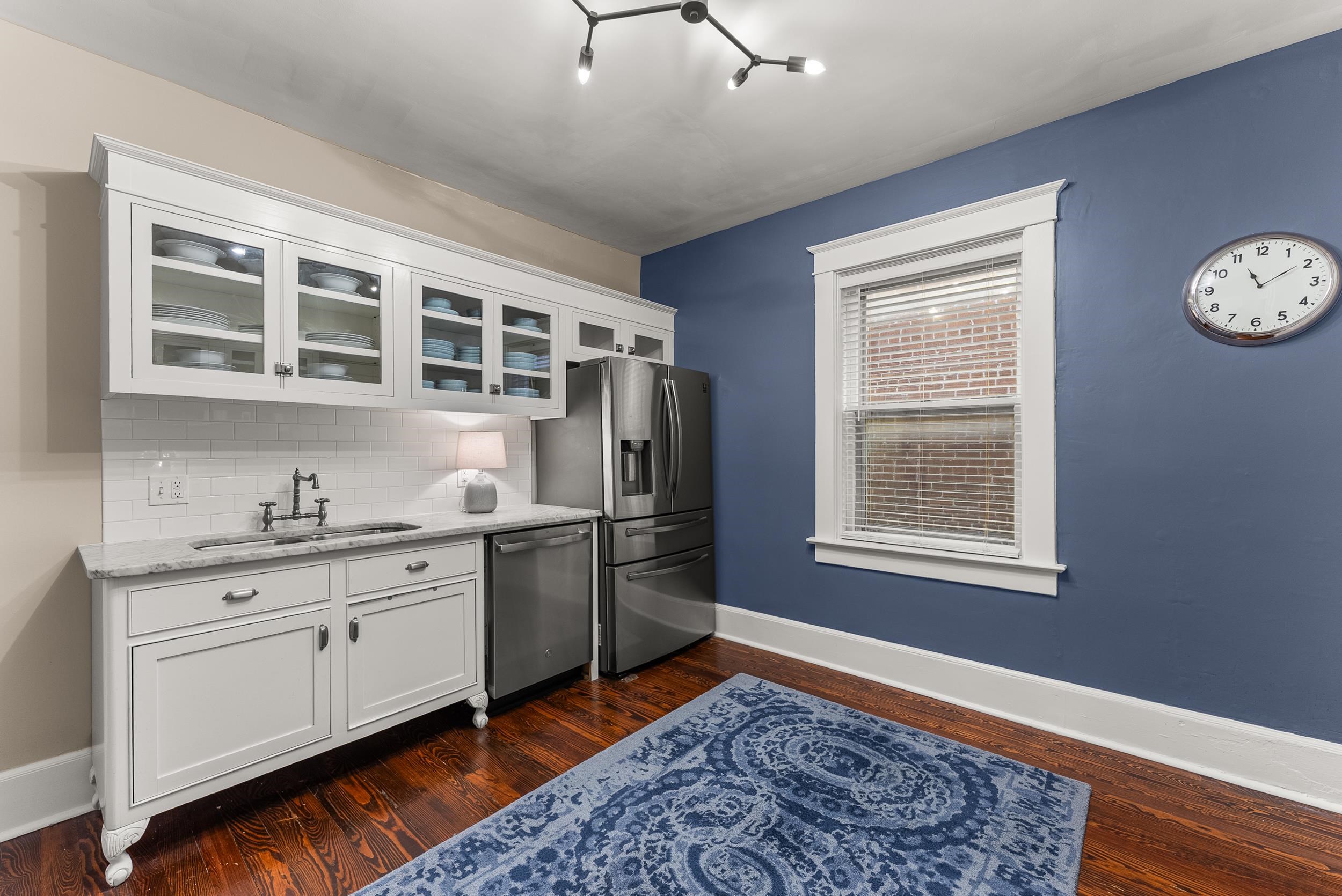 1116 Poplar Avenue, Unit 3 Memphis, TN 38105 - Photo 17 of 25 Kitchen featuring glass insert cabinets, dark wood finished floors, and white cabinets