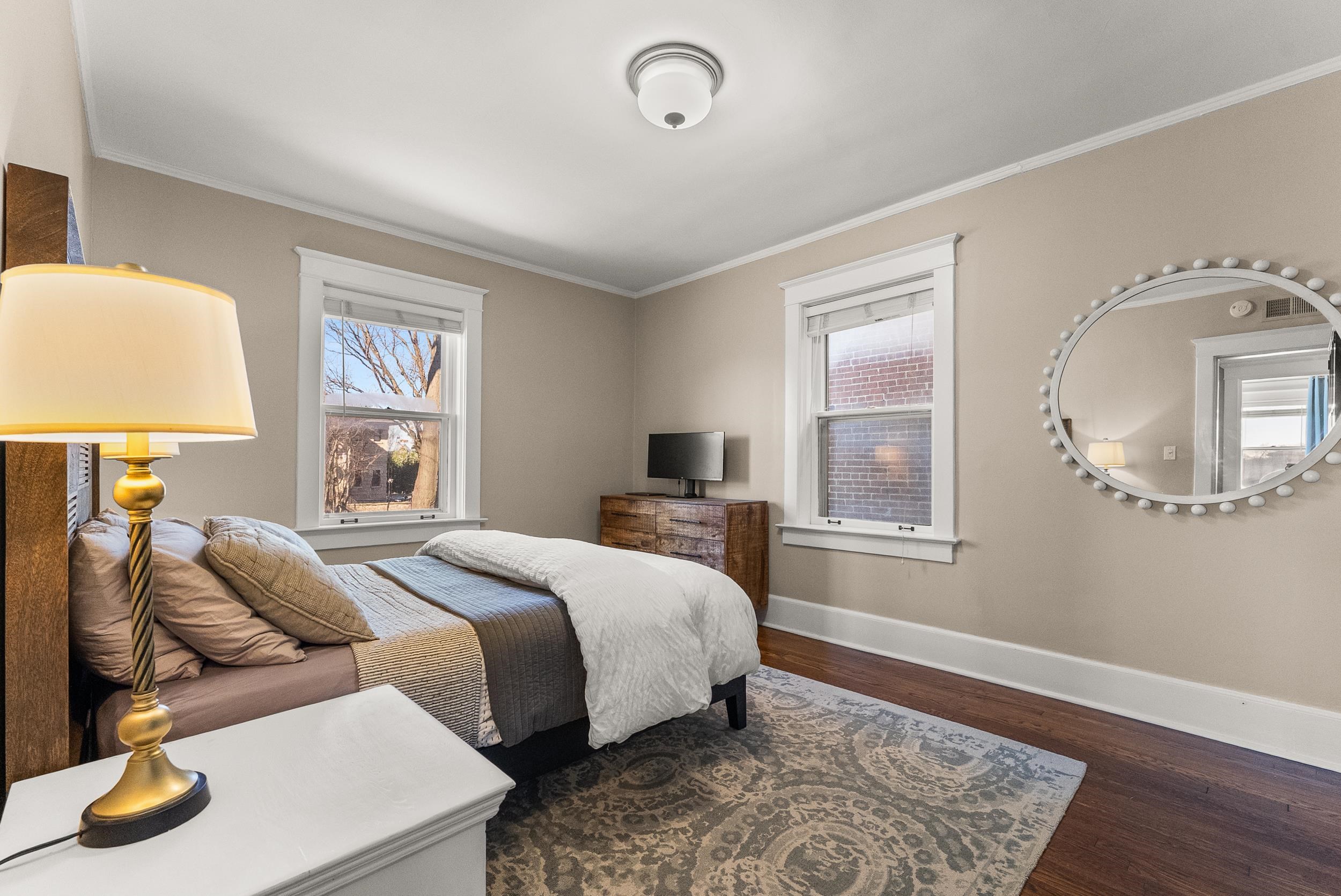 1116 Poplar Avenue, Unit 3 Memphis, TN 38105 - Photo 22 of 25 Bedroom featuring dark wood-style floors, ornamental molding, and multiple windows