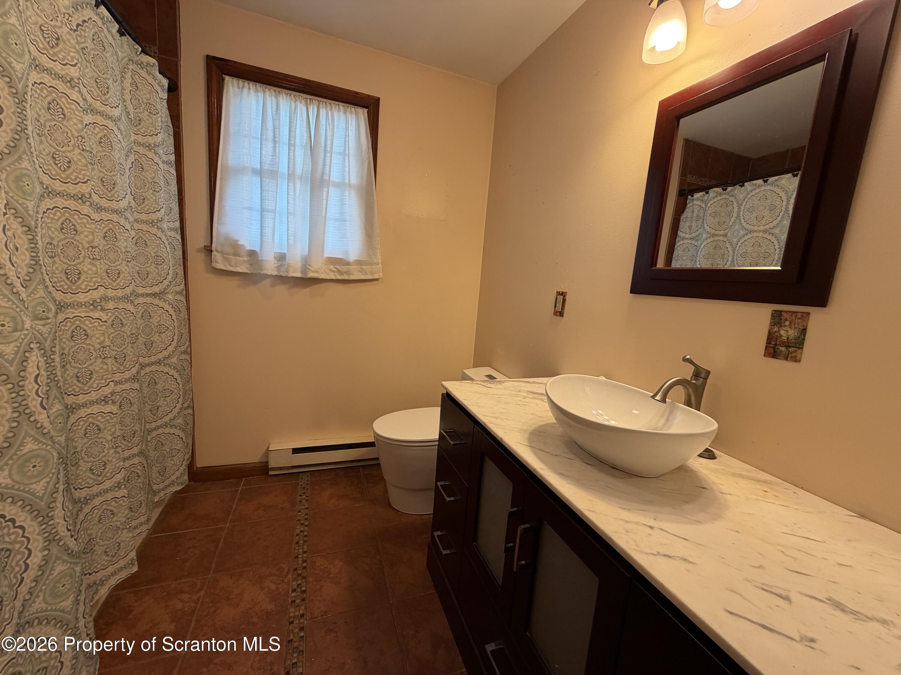 1019 Moosic Street Scranton, PA 18505 - Photo 23 of 43 a bathroom with a granite countertop sink and a mirror