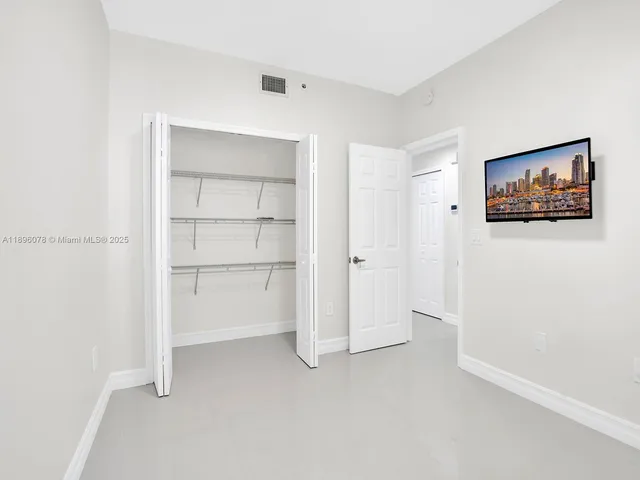 a view of an empty room with closet