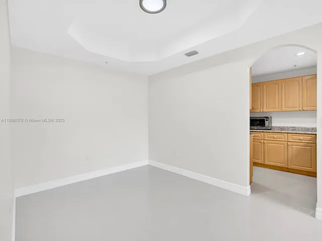 a view of a kitchen with white cabinets and a stove