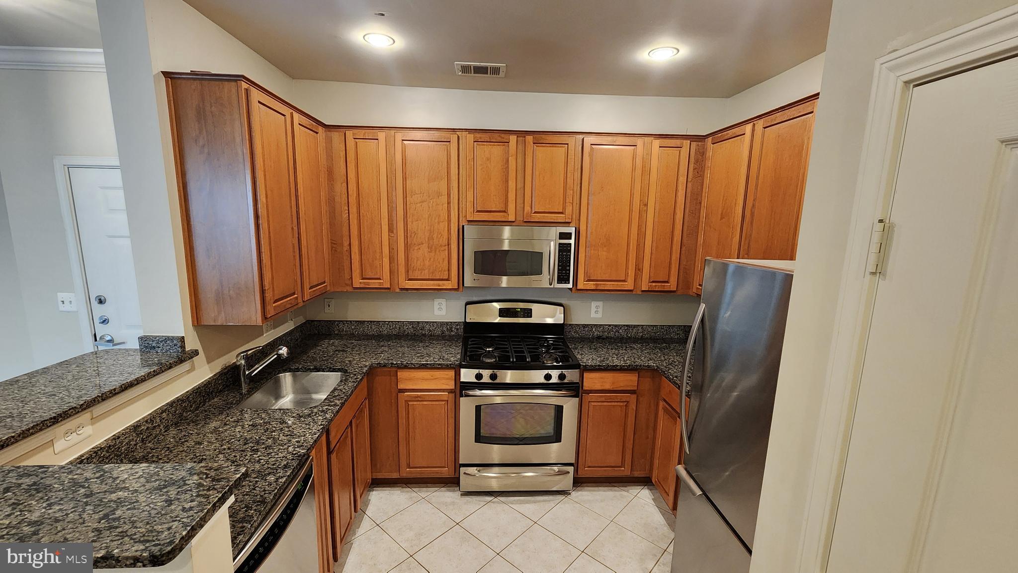 a kitchen with a stove and a refrigerator