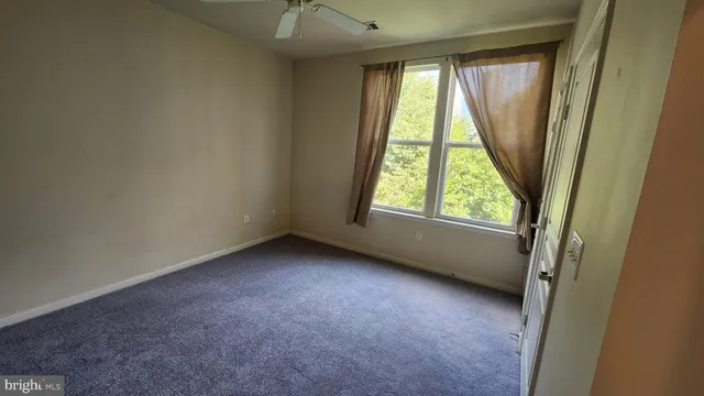 an empty room with windows and closet