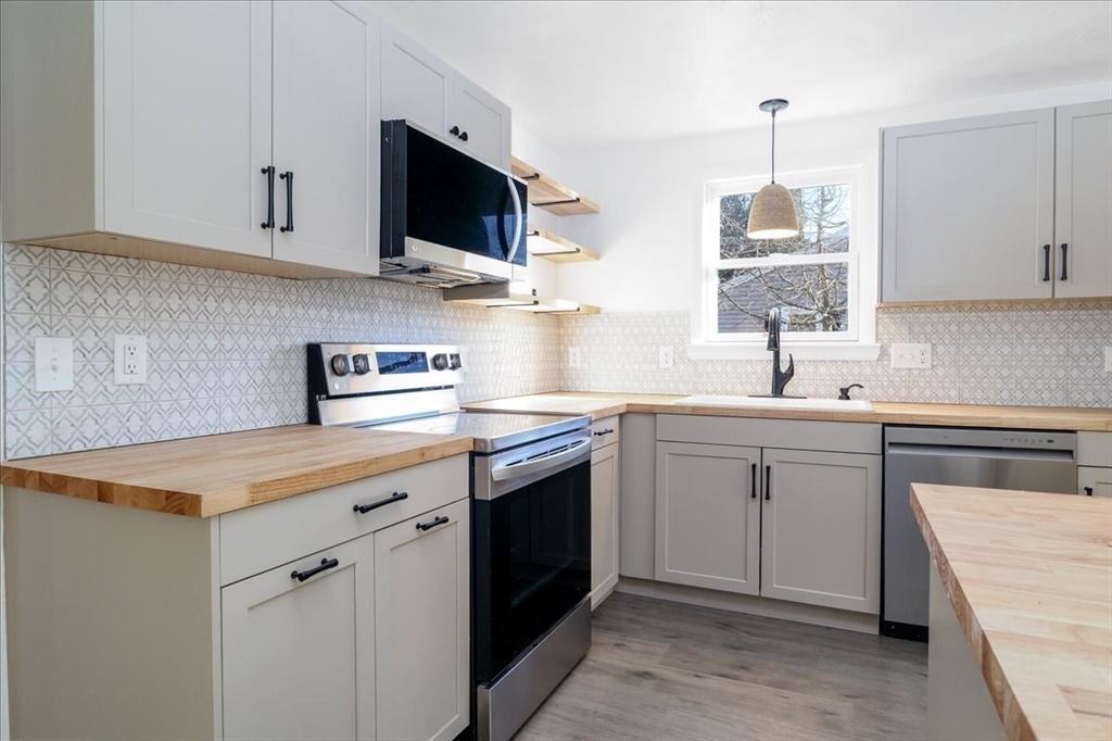 18 Claffey Avenue Worcester, MA 01606 - Photo 12 of 39 a kitchen with a sink stove and microwave