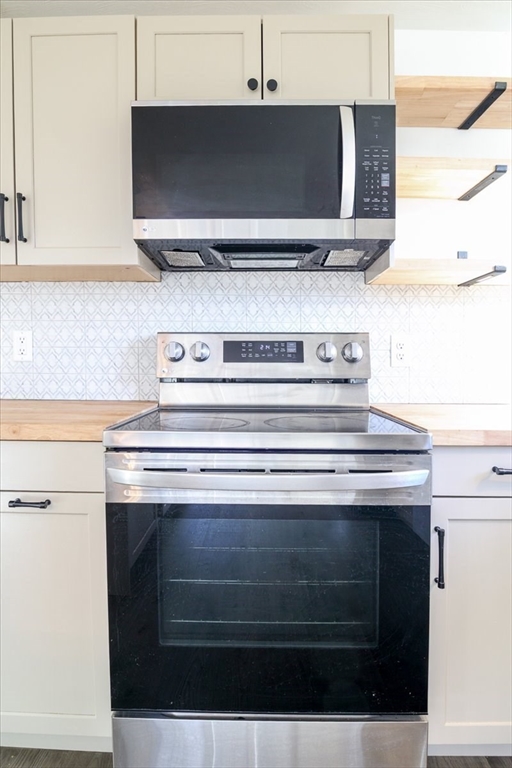 18 Claffey Avenue Worcester, MA 01606 - Photo 13 of 39 a stove top oven sitting inside of a kitchen