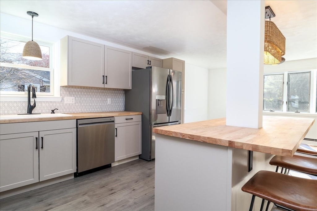 18 Claffey Avenue Worcester, MA 01606 - Photo 16 of 39 a kitchen with stainless steel appliances granite countertop a sink stove and refrigerator