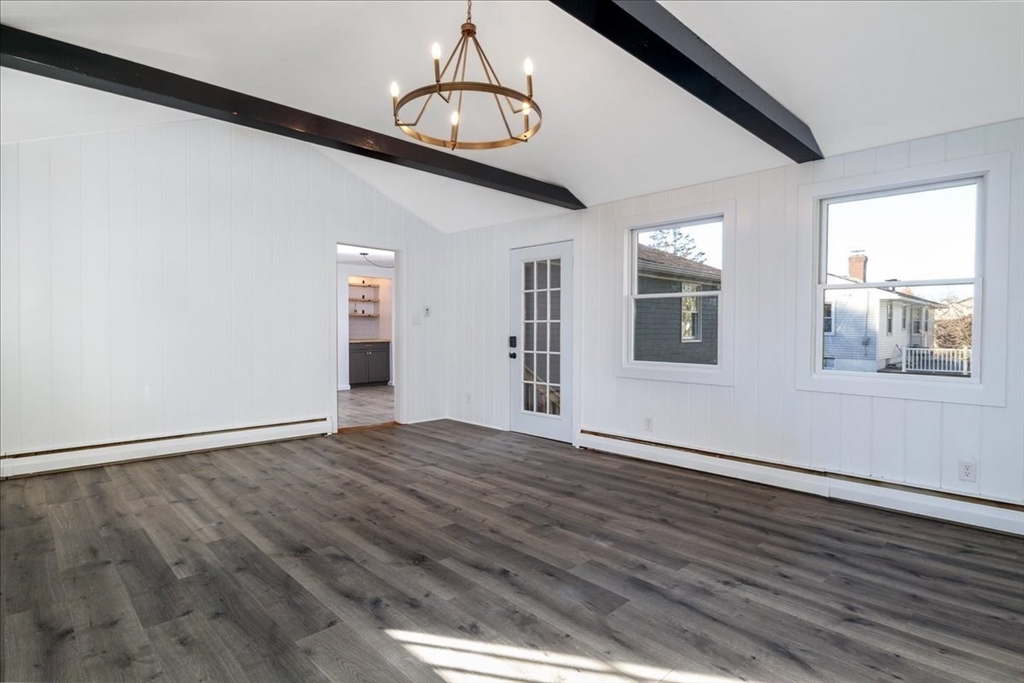 18 Claffey Avenue Worcester, MA 01606 - Photo 22 of 39 a view of an empty room with wooden floor and windows