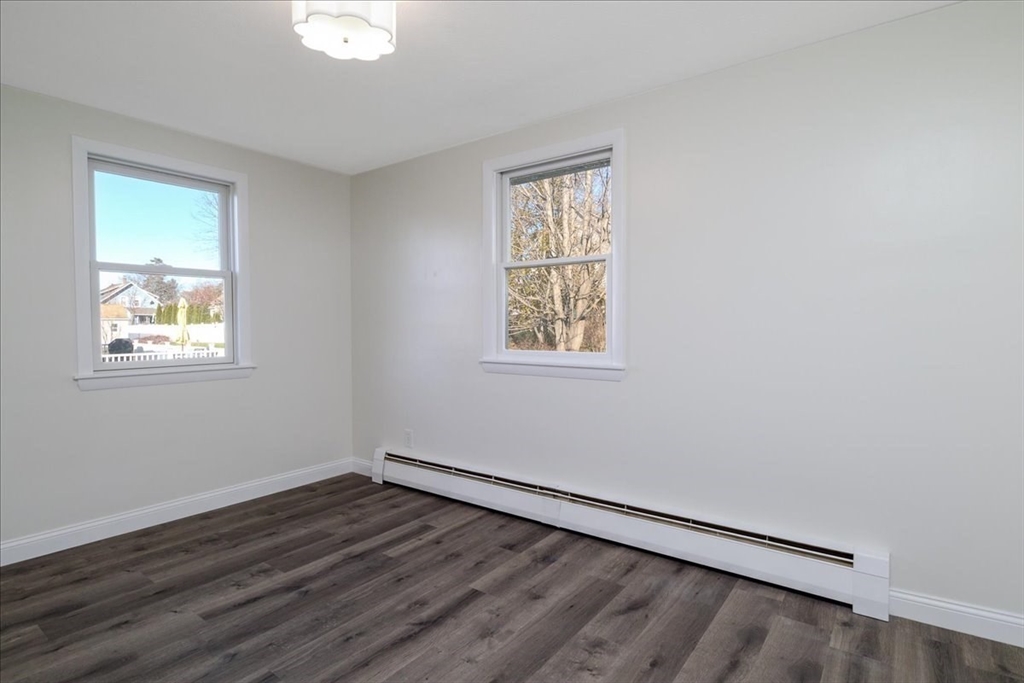 18 Claffey Avenue Worcester, MA 01606 - Photo 26 of 39 a view of an empty room with wooden floor and a window