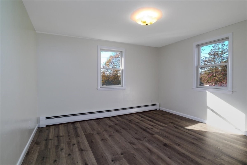 18 Claffey Avenue Worcester, MA 01606 - Photo 28 of 39 a view of an empty room with wooden floor and a window