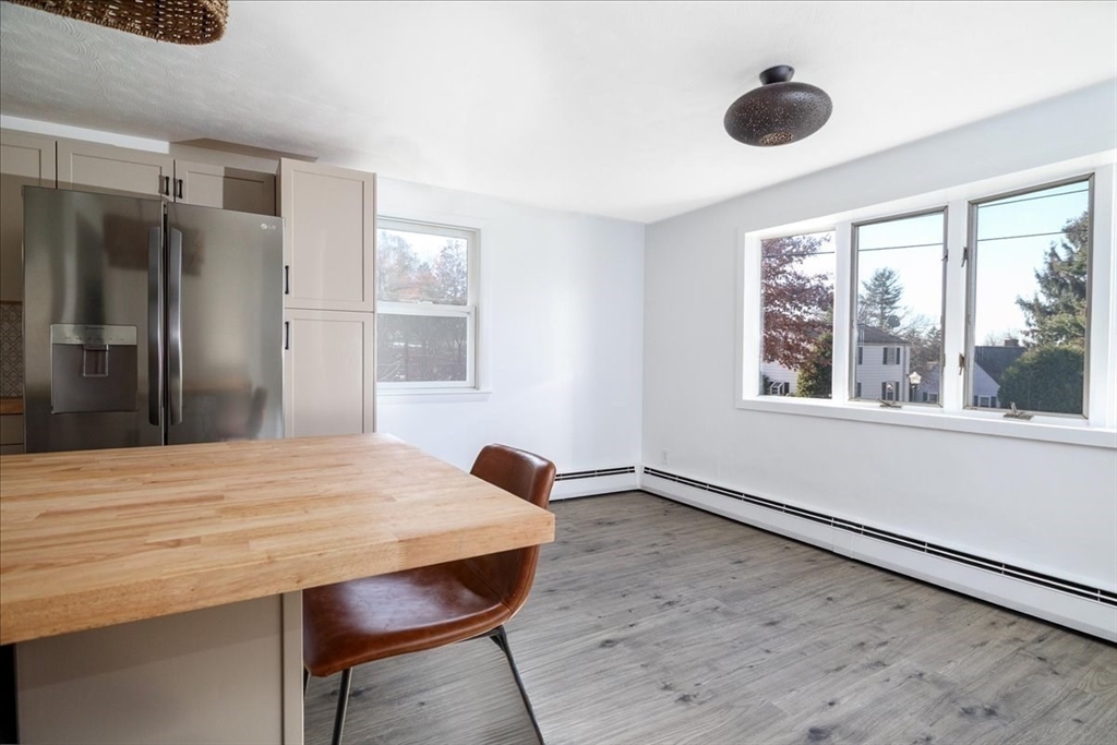 18 Claffey Avenue Worcester, MA 01606 - Photo 4 of 39 a workspace with stainless steel appliances wooden floor and a large window