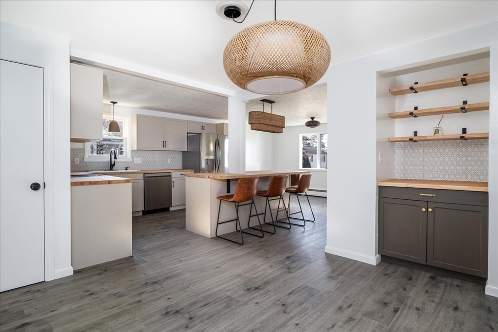 18 Claffey Avenue Worcester, MA 01606 - Photo 5 of 39 a kitchen with stainless steel appliances a dining table chairs and wooden floor
