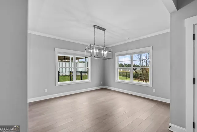 an empty room with windows and entrance