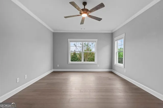 wooden floor in an empty room with a window